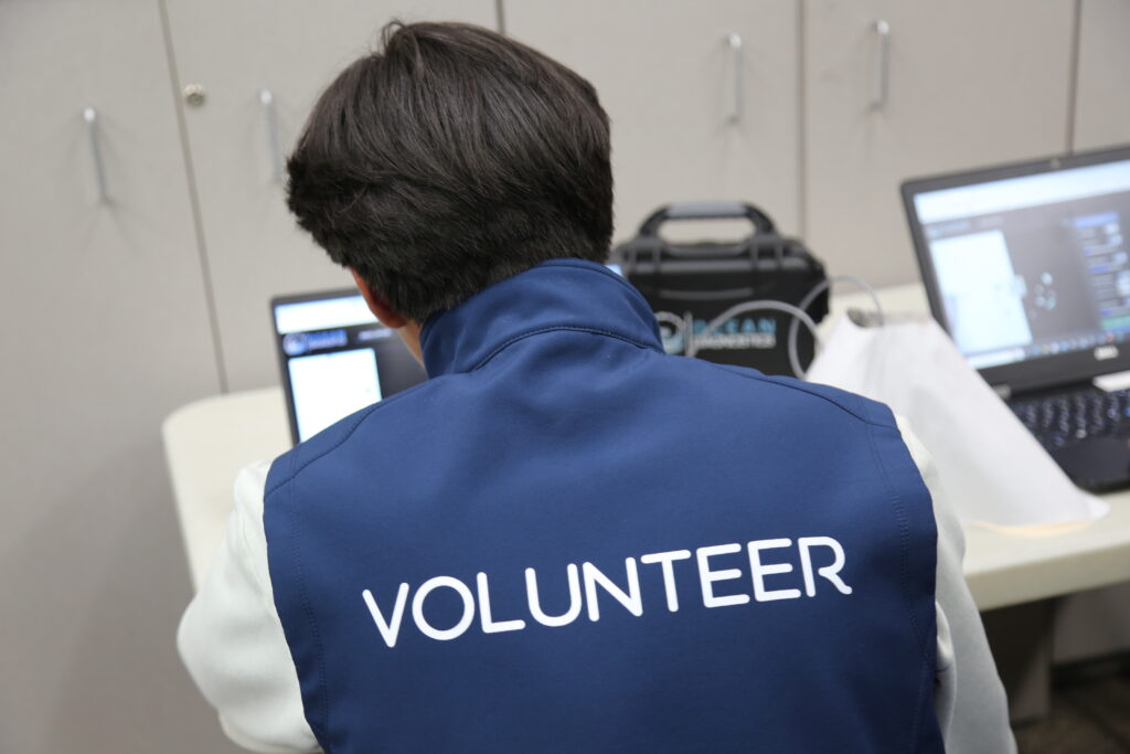 A Bilingual Youth Program participant observes findings on a laptop