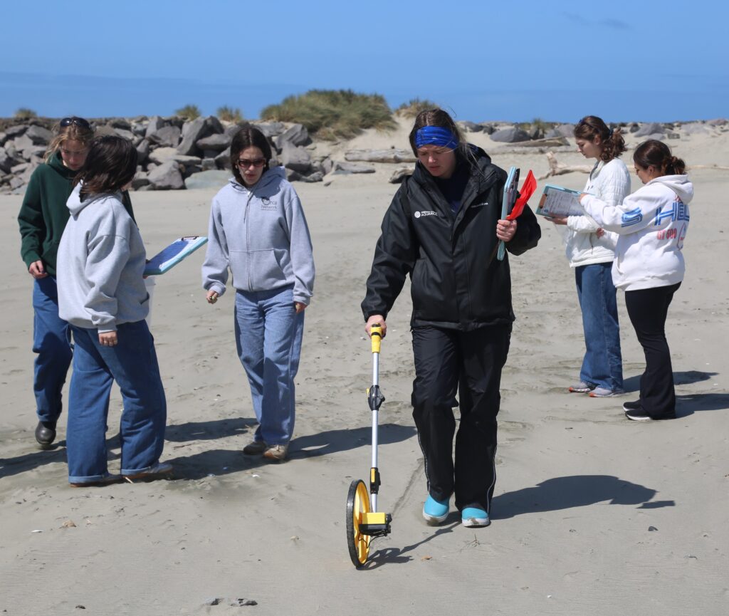 Shelby measures a transect where nurdles and other microplastics will be collected and recorded